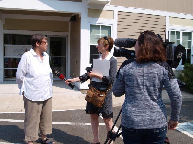 Executive Director Lois Corbett speaking with Catherine Harrop of CBC News at the announcement of the Association of Professional Geoscientists and Engineers of New Brunswick's solar panel installation on Wednesday, Sept. 2.