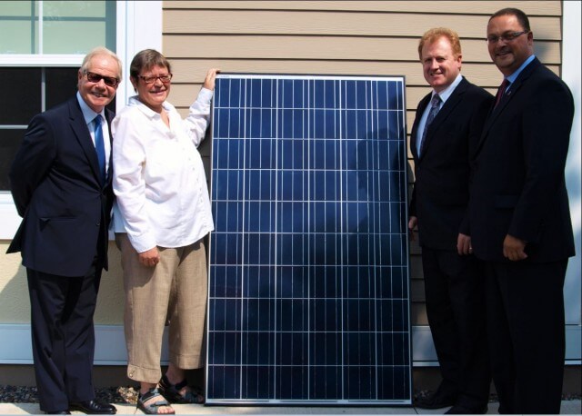Paul Campbell, president of the Association of Professional Engineers and Geoscientists of New Brunswick, far left, with Lois Corbett, Executive Director of the Conservation Council of New Brunswick, left, with Minister of Environment Brian Kenny, right, and Minister of Energy and Mines Donald Arseneault at the launch of APEGNB's solar panel array in Fredericton, the largest solar installation in New Brunswick.