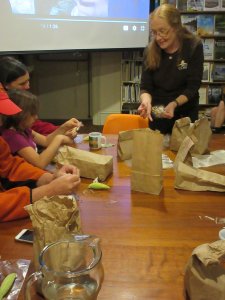 Nadine shows workshop attendees what milkweed seeds look like after pods have burst open to disperse seeds.