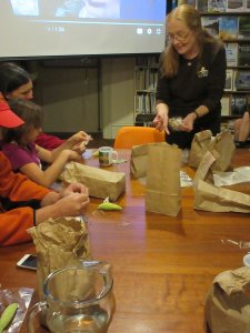 Nadine shows workshop attendees what milkweed seeds look like after pods have burst open to disperse seeds. 